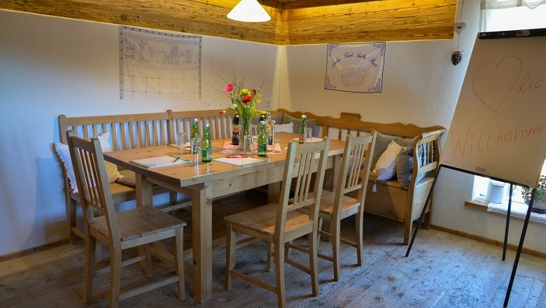 Also very suitable for seminars, © Berggasthof Mönichkirchner Schwaig Cozy seminar room with wooden table, chairs and flipchart.