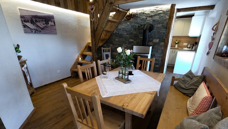 Rustic rooms provide a unique flair, © GO Pro Peter-10 Cozy dining area with wooden furniture and fireplace.