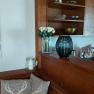 Wooden kitchen with shelves, cushions and decorations.