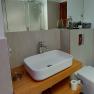 Modern bathroom with washbasin, toilet and shower.
