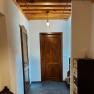 A hallway with wooden doors, wooden ceiling and modern lamps.