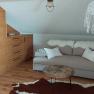 Cozy room with pull-out couch, wooden furniture and dream catcher.