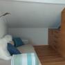 Double room on the upper floor with pull-out couch, wooden floor and wardrobe.