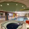 Indoor pool area with whirlpool and sun loungers at Hotel Thier.